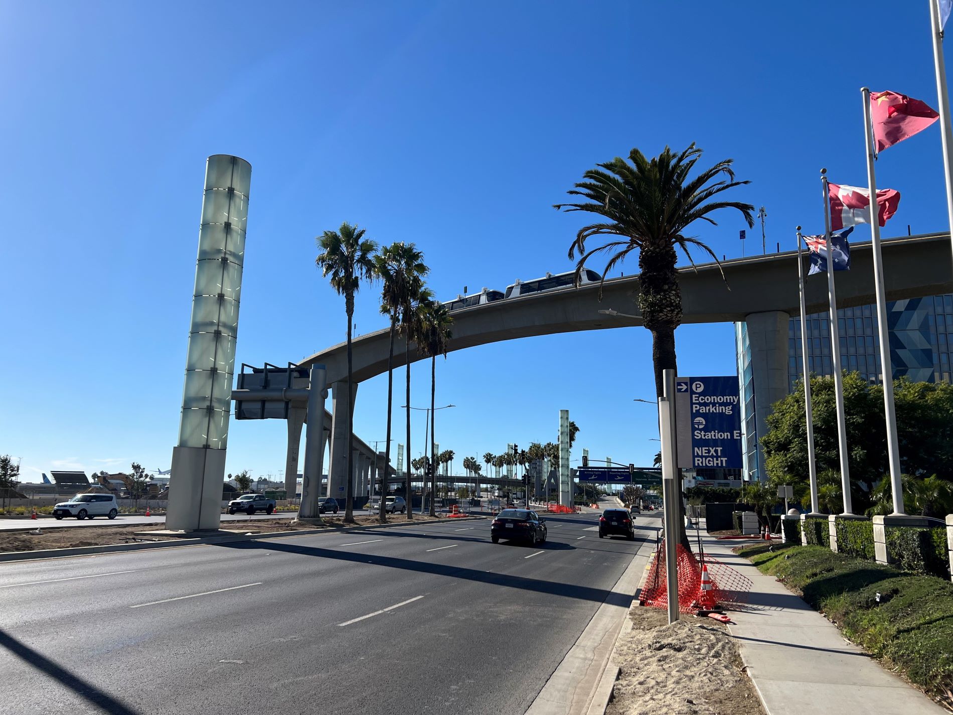 Automated People Mover train cars moving across the train guideway over Century Boulevard.