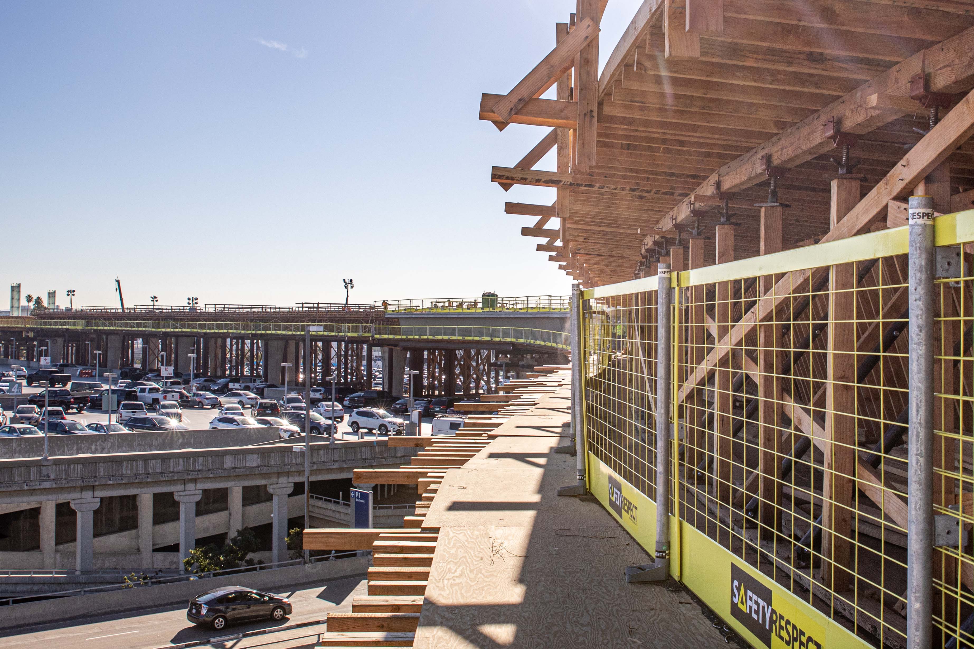 Formwork has been stripped from a segment of guideway at the future East Central Terminal Area (CTA) station, revealing the first segment of completed guideway superstructure within the CTA.