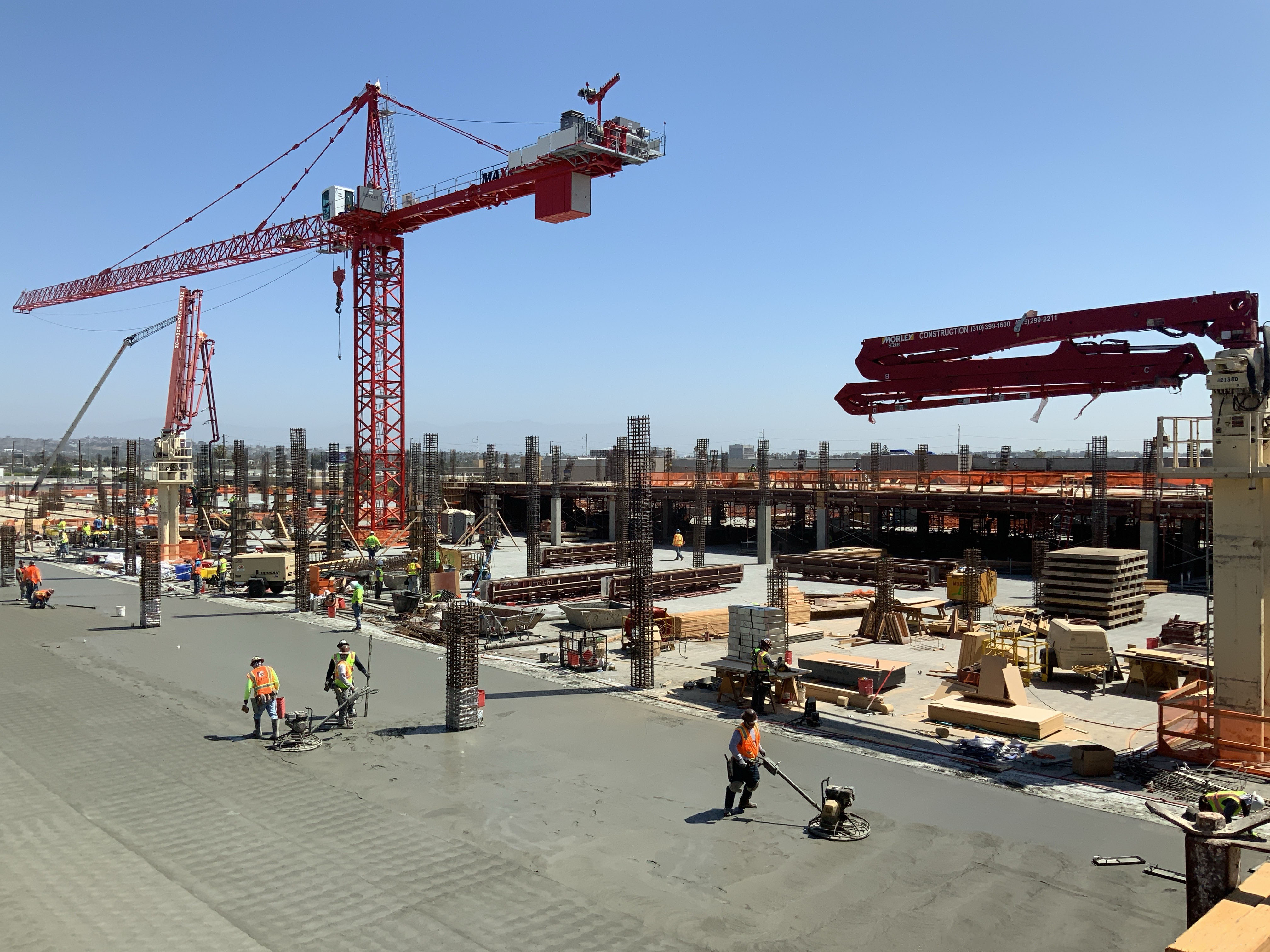 Concrete finishers wrapping up a deck pour on the third level of the Idle Storage building of the Consolidated Rent-A-Car facility. 